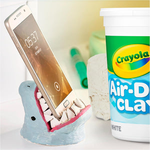 Close-up of the soft, smooth, and malleable white modeling clay being shaped by hands.